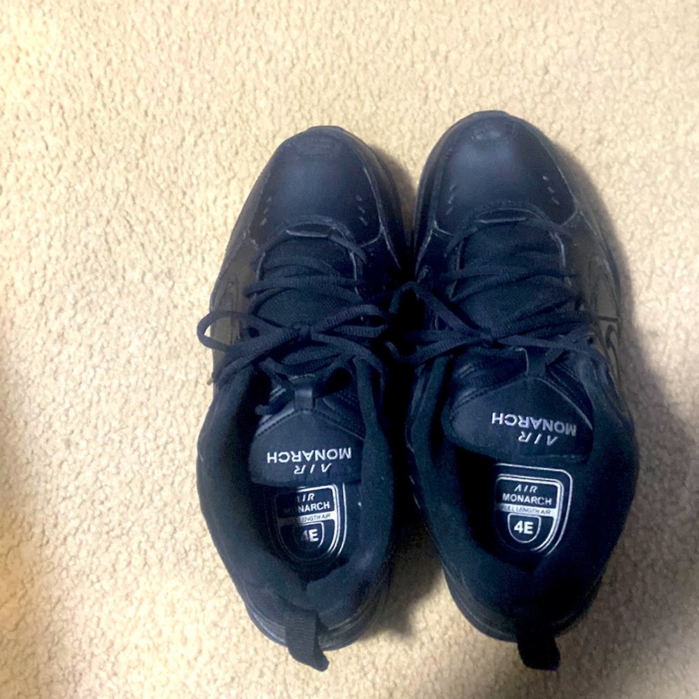 A black pair of nike air monarch size 101/2 wide